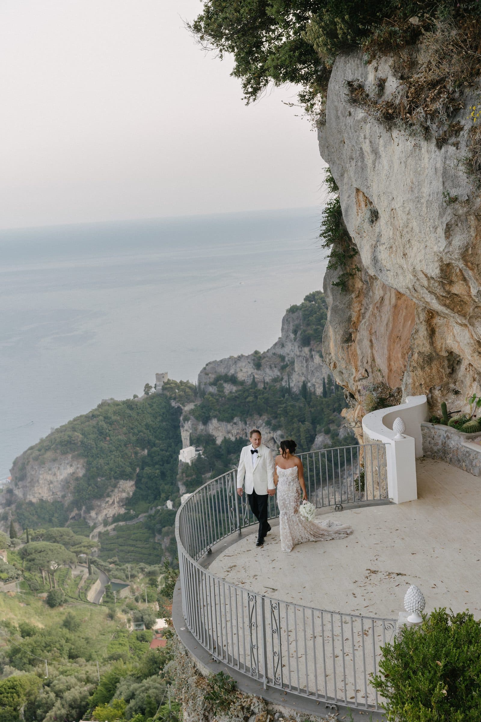 Bride and groom on a terrace high above the sea on the Amalfi Coast