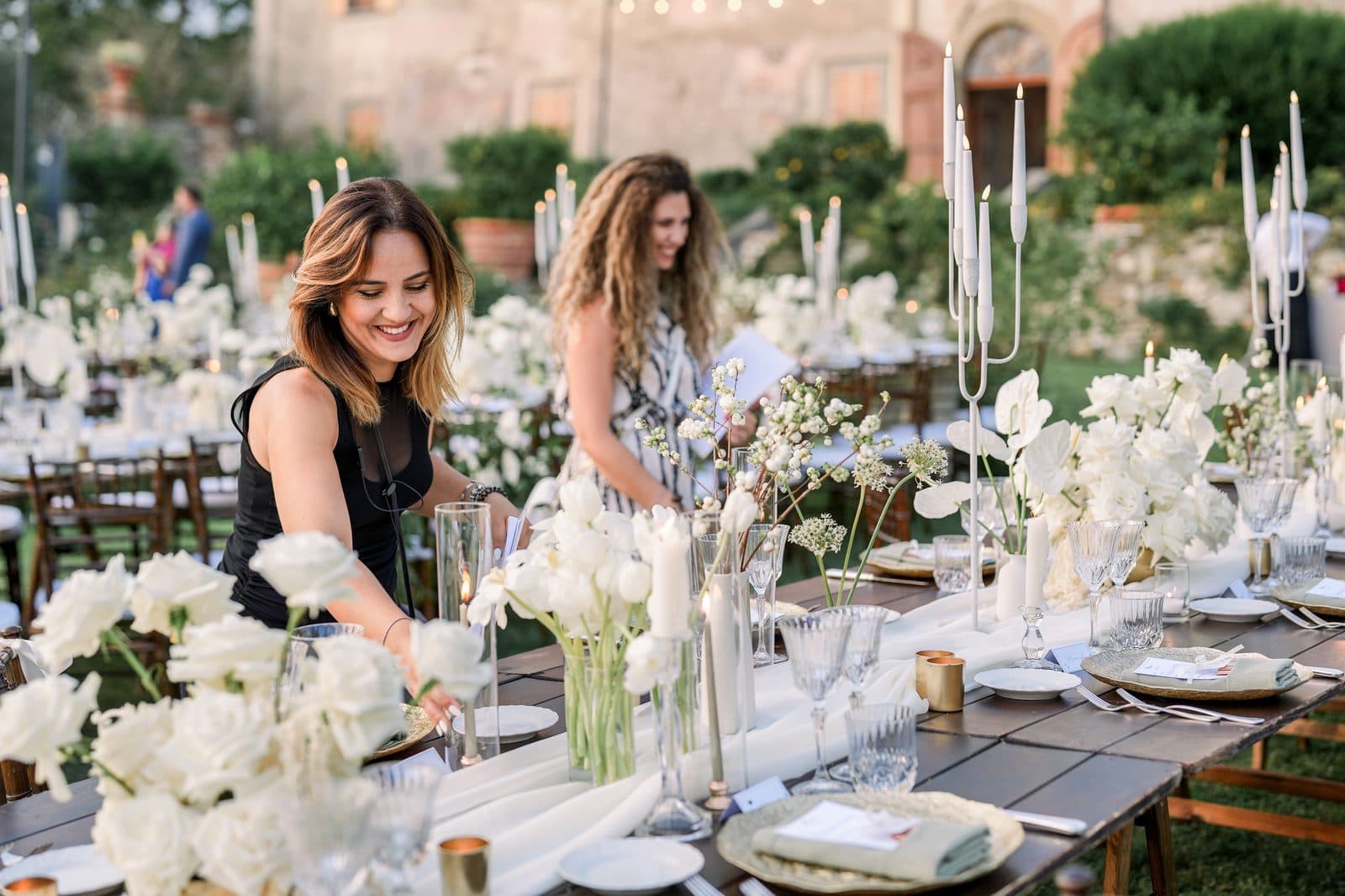 Enza and Roberta checking the table setting before a reception